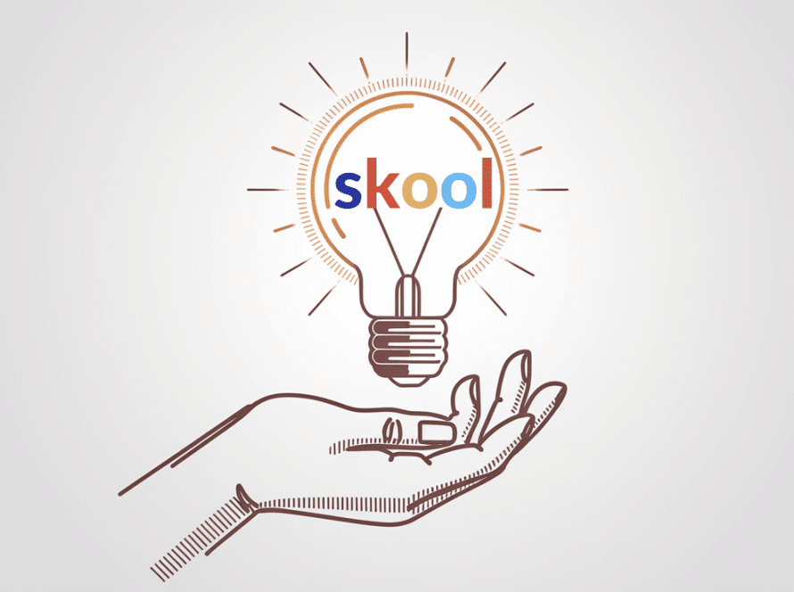 A hand offering a glowing lightbulb with "Skool" embedded in it.